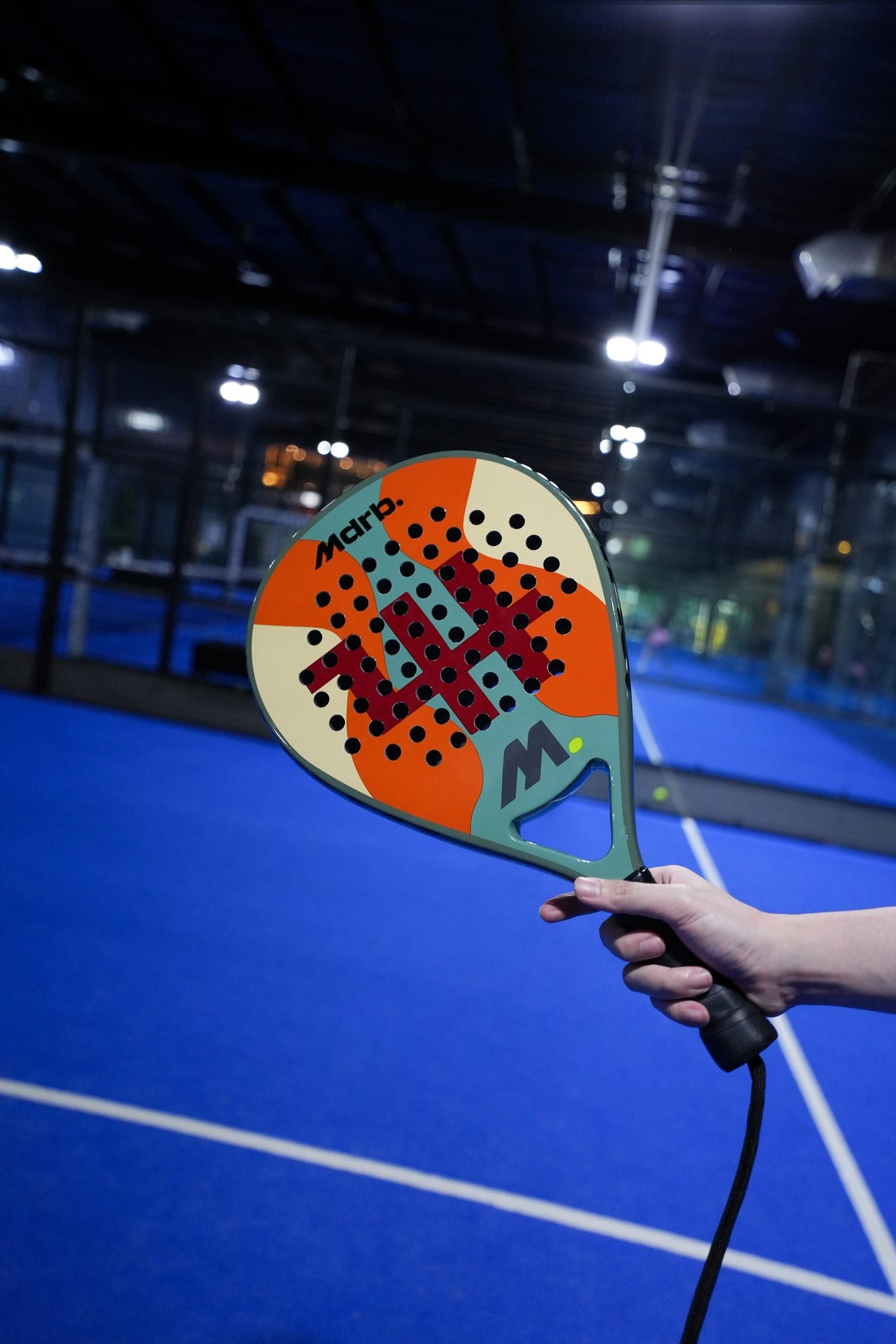 MDRB Camel Edition padel racket held up on court