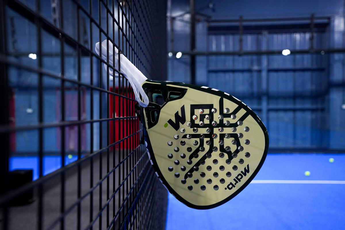MDRB UAE Falcon Edition padel racket hanging on the court fence