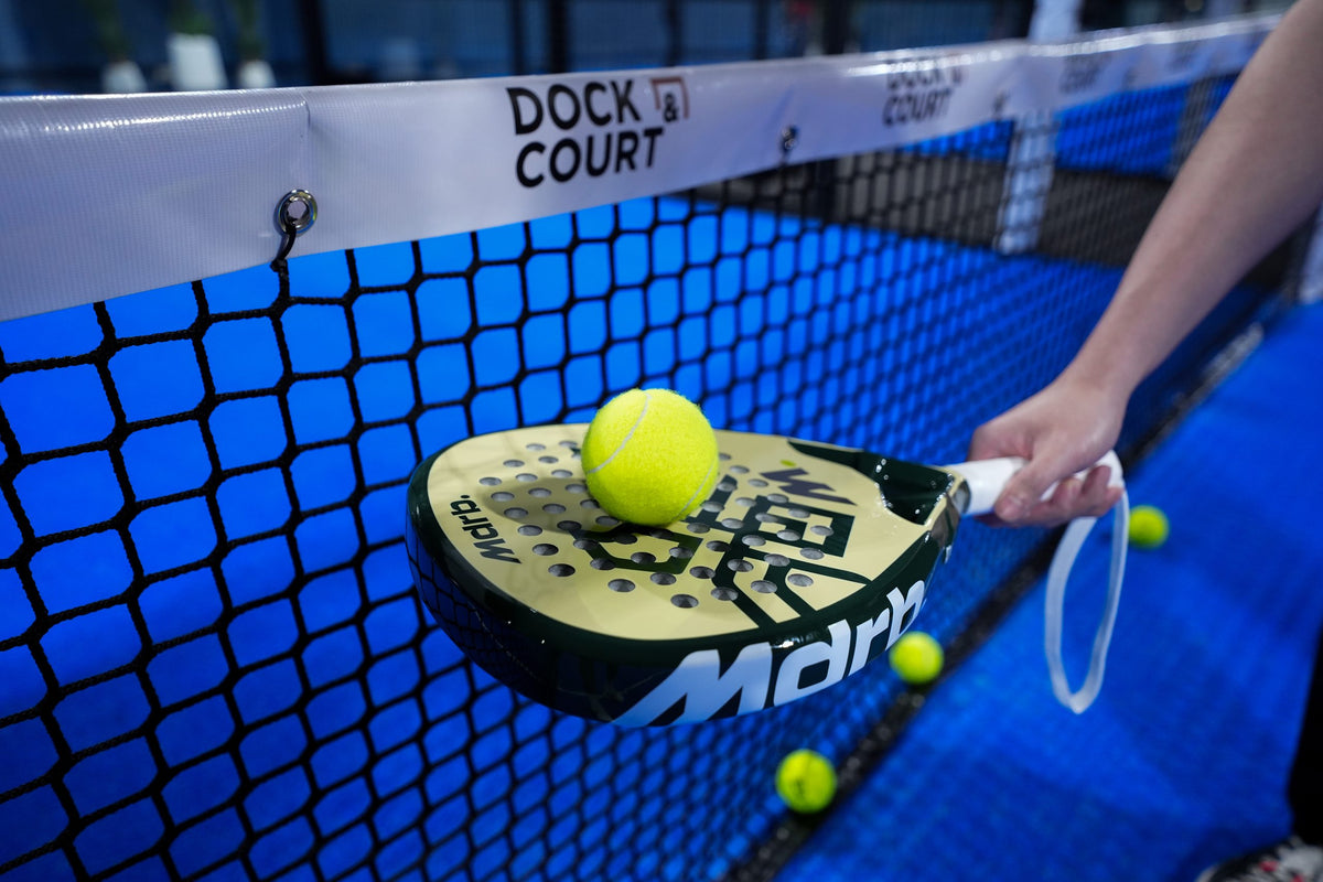 MDRB UAE Falcon Edition padel racket balancing a ball over the net