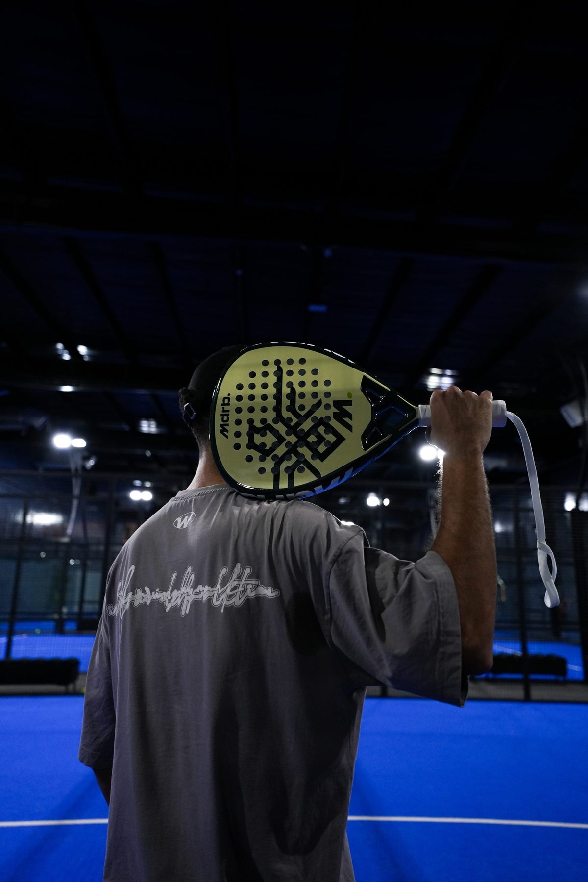 Player seen from behind with the MDRB UAE Falcon Edition padel racket on their shoulder