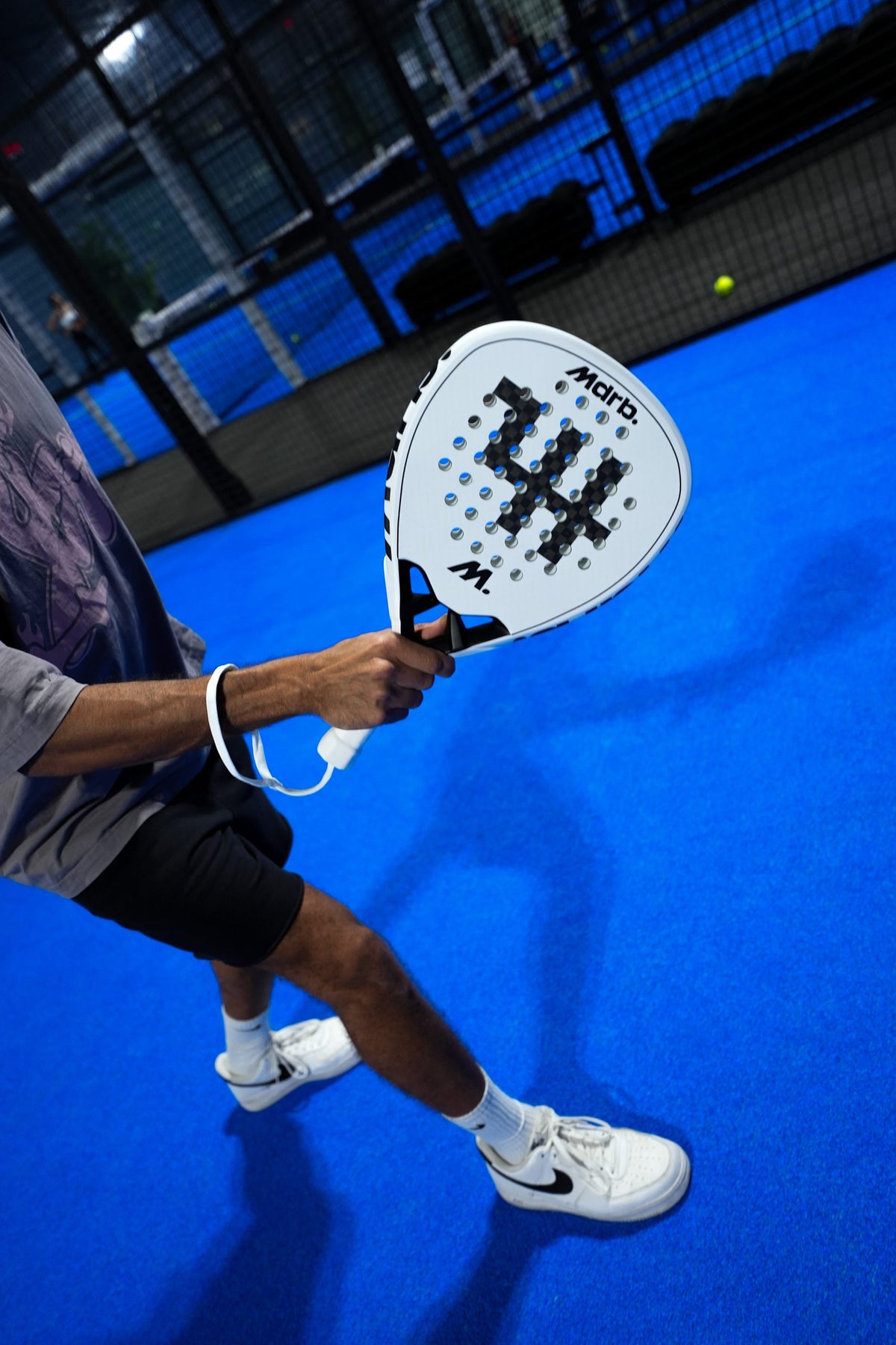 Player playing a low volley with the MDRB Vellum Ghost padel racket